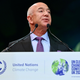 Jeff Bezos talks in front of a podium with the logos of the United Nations Framework Convention on Climate Change and COP26 in Glasgow.